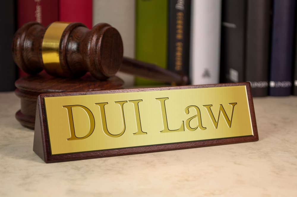 "Upholding DUI Law: Drive Sober, Arrive Safe" - A golden sign featuring a gavel icon, emphasizing the importance of abiding by DUI laws for a safer community.