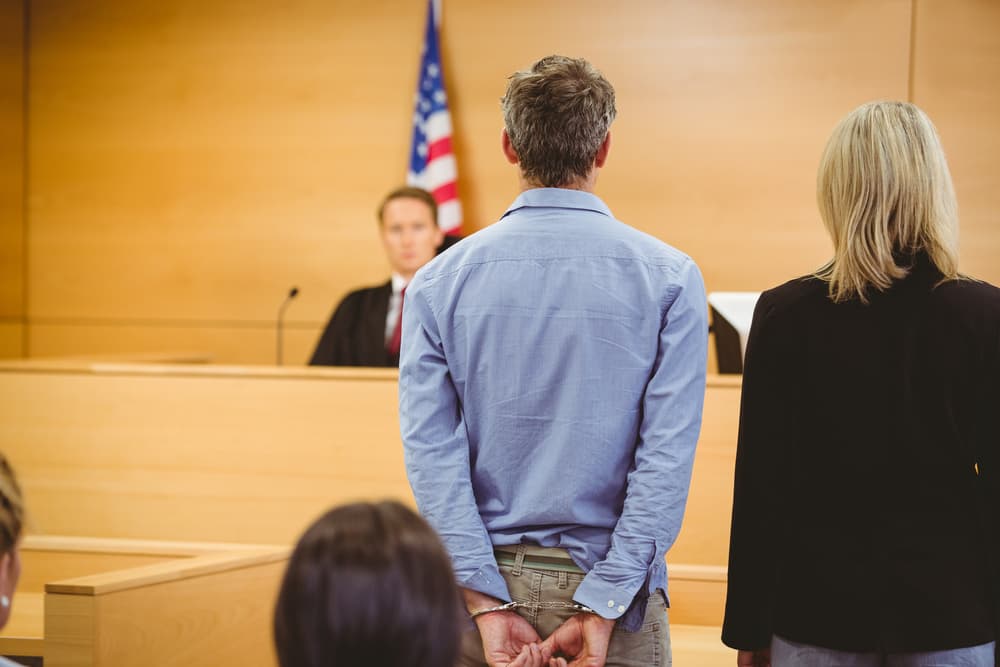 A criminal awaits the court's decision in the courtroom.