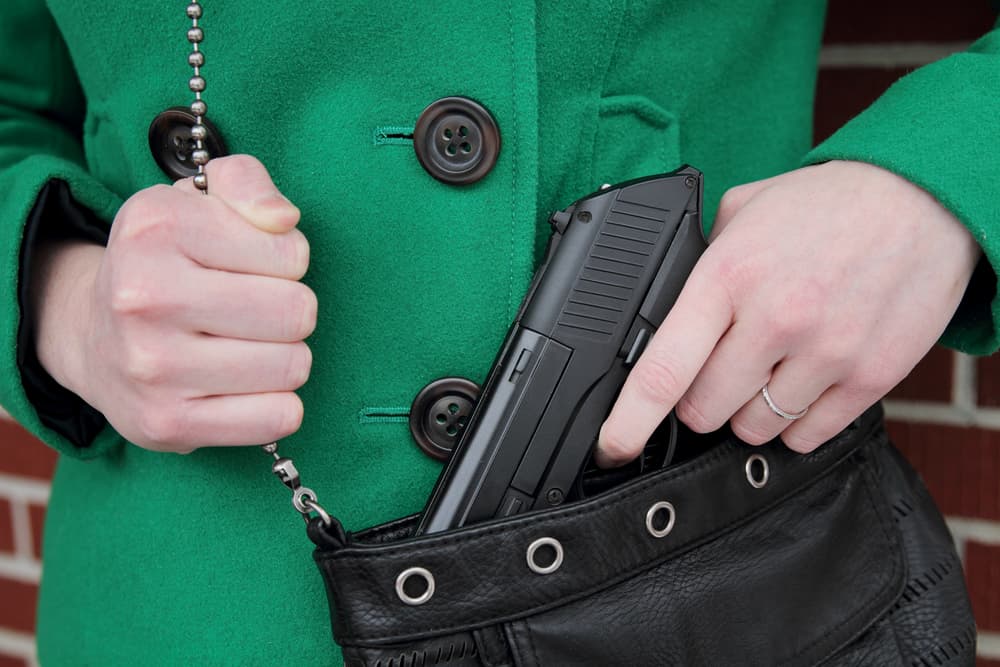A woman carrying a concealed weapon for self-defense.