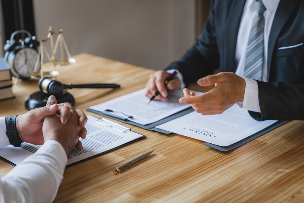 The lawyer working with a client discussing contract paper, 