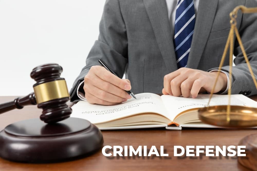 A professional image symbolizing criminal defense, showcasing a gavel, handcuffs, and legal documents arranged on a desk.