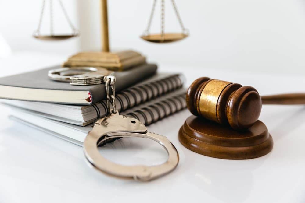 Handcuffs and a wooden gavel symbolizing law, crime, and justice.