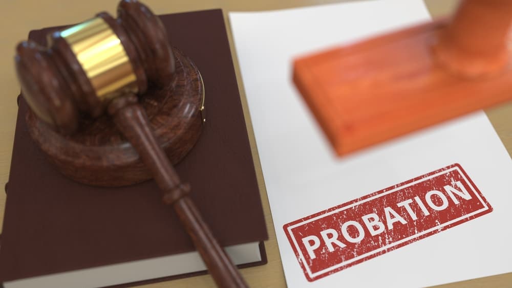 3D rendering of a wooden gavel and a probation stamp on a legal document, representing a court-related scene.