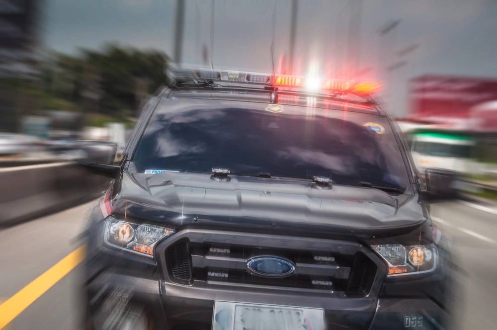 Speeding vehicle driving away, illustrating carjacking offenses under California Penal Code § 215 and the serious criminal charges that may result.