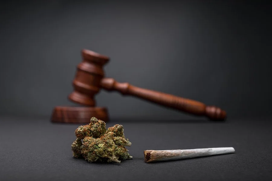 Cannabis, a rolled joint, and a gavel displayed together, illustrating drug DUI (DUID) charges and California law regarding driving under the influence of drugs.