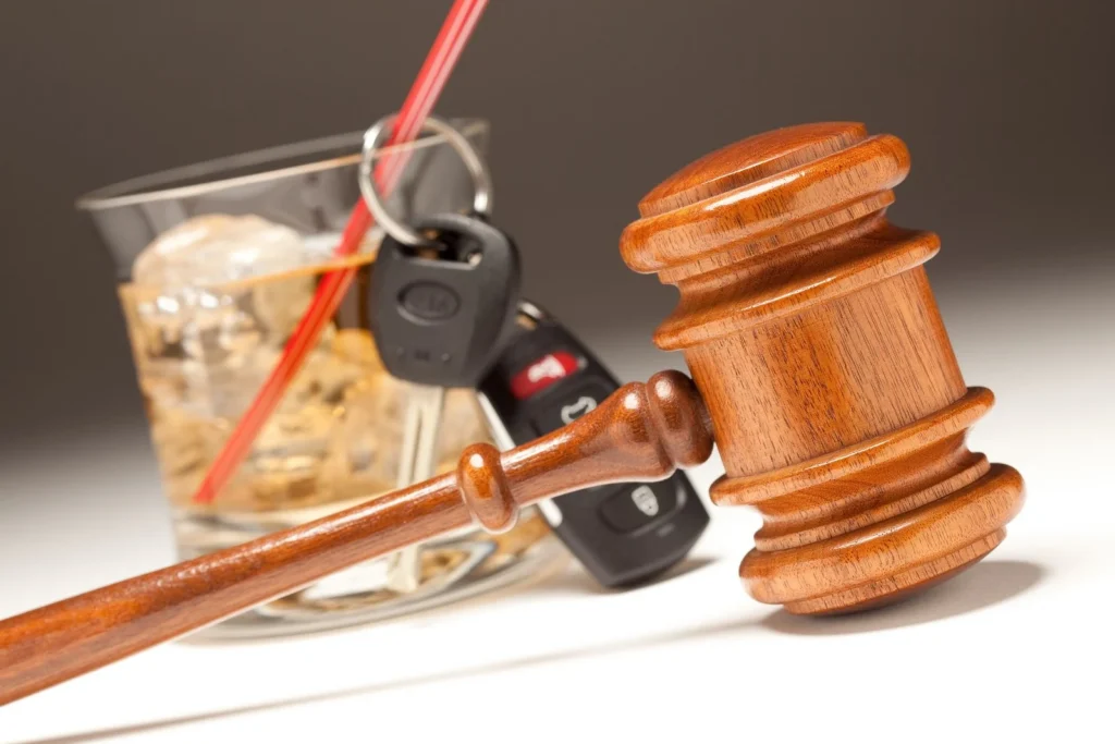 Alcoholic drink, car keys, and a gavel displayed together, illustrating the increased legal consequences of a second DUI charge in Los Angeles.