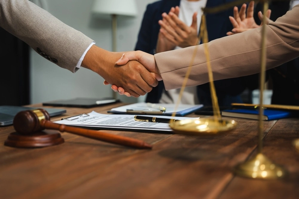 Client shaking hands with a Los Angeles theft and property crimes lawyer, illustrating Chudnovsky Law's commitment to trusted criminal defense representation.